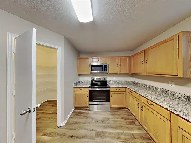a kitchen with stainless steel appliances granite countertop a stove and a sink