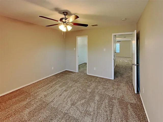 a view of a livingroom with a chandelier fan