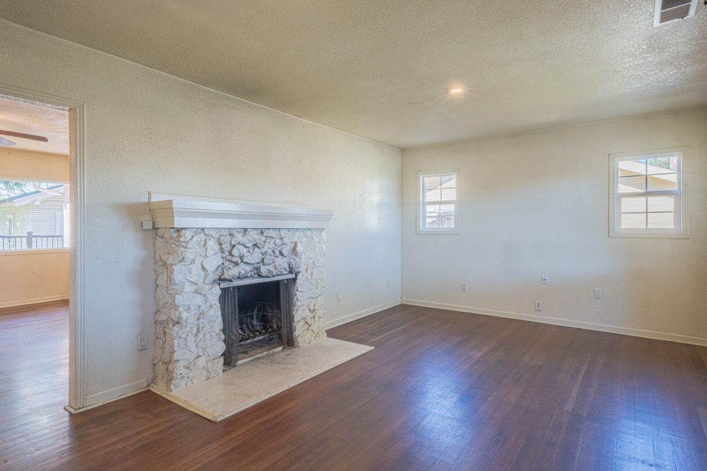 40 Oak Street Salinas, CA 93901 - Photo 4 of 28 an empty room with wooden floor and fireplace