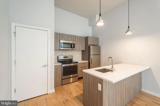 a view of a kitchen with a sink and cabinets