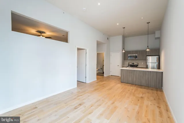 a view of empty room with wooden floor