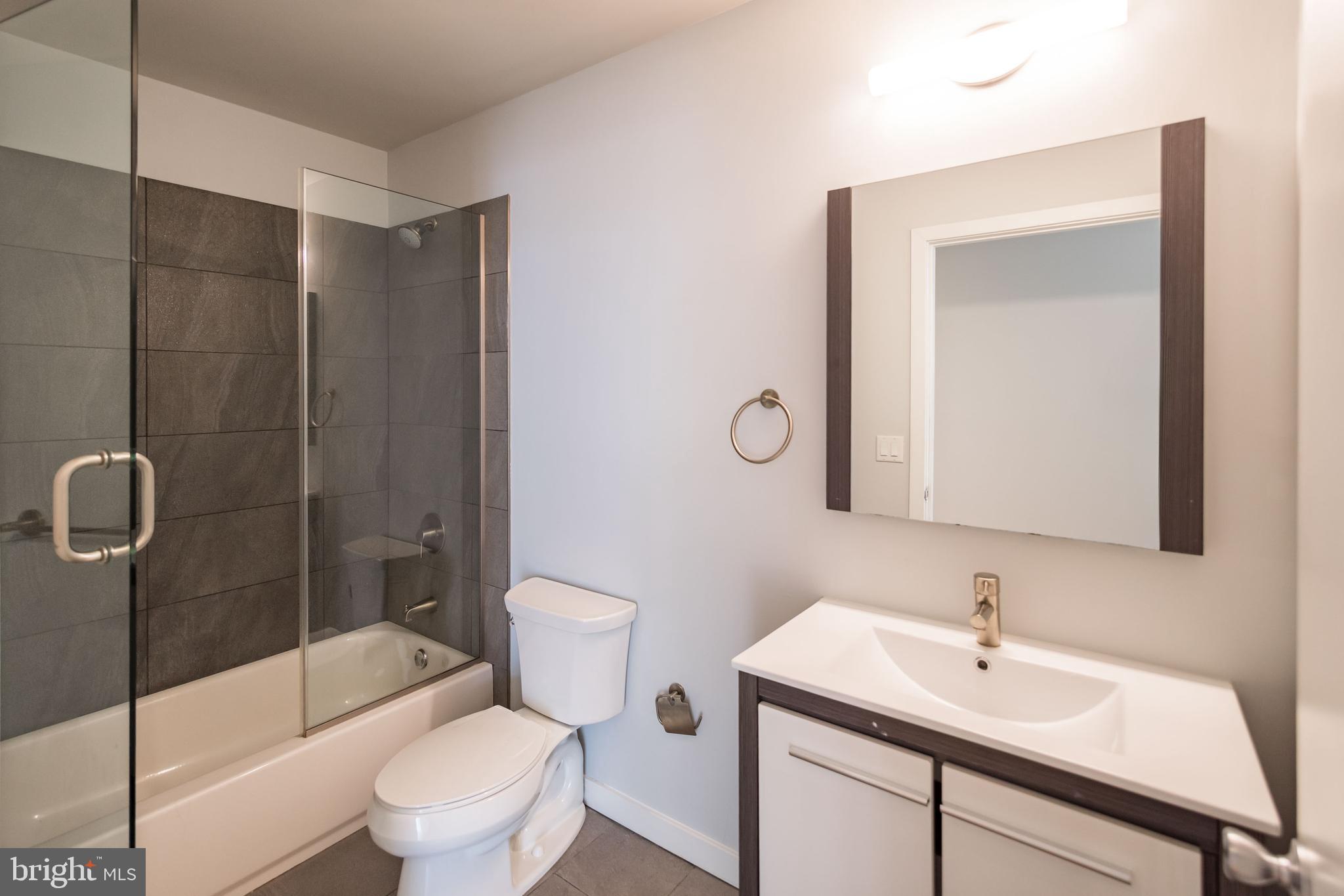 412 South 13th Street, Unit 608 Philadelphia, PA 19147 - Photo 10 of 18 a bathroom with a sink toilet and shower