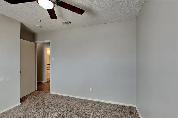an empty room with a ceiling fan