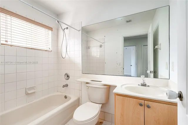 a bathroom with a bathtub a sink a vanity and a shower