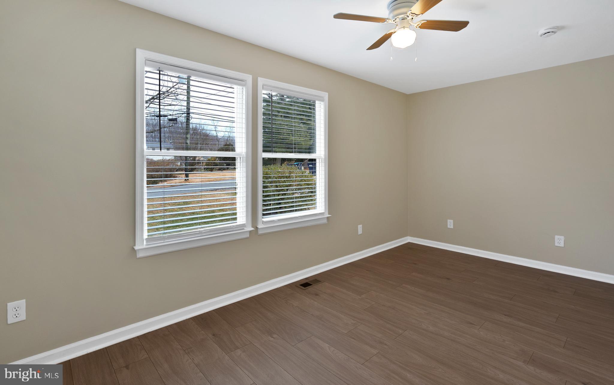 122 Garris Road Downingtown, PA 19335 - Photo 16 of 52 a view of an empty room with wooden floor and a window