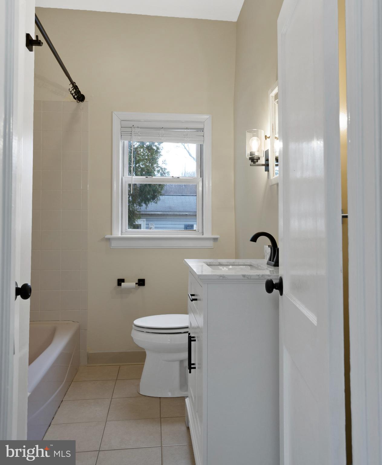 122 Garris Road Downingtown, PA 19335 - Photo 23 of 52 a bathroom with a toilet a sink a mirror a window and vanity