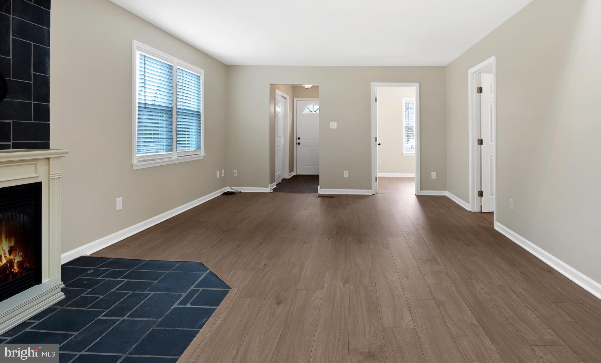 122 Garris Road Downingtown, PA 19335 - Photo 4 of 52 an empty room with wooden floor and windows