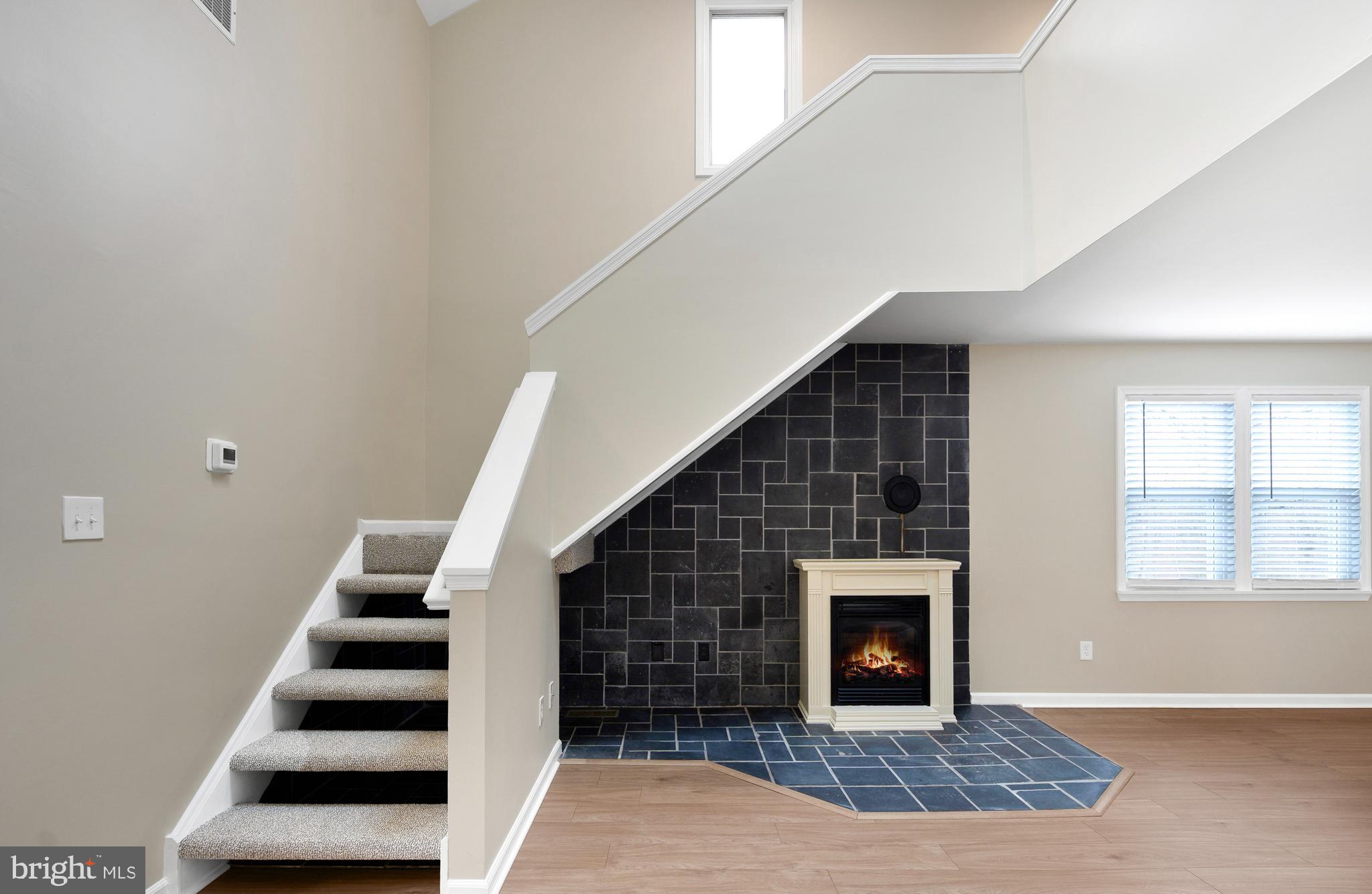 122 Garris Road Downingtown, PA 19335 - Photo 7 of 52 a view of a livingroom with stairs and fireplace