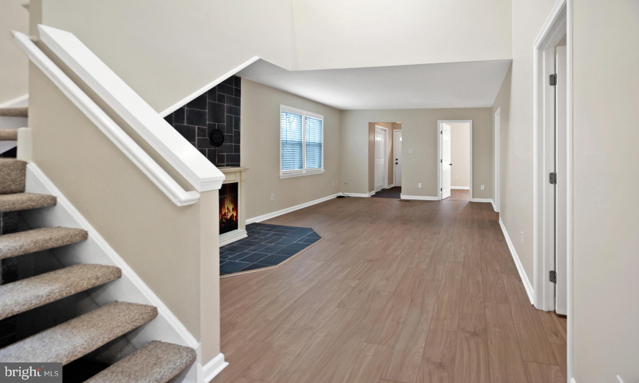 122 Garris Road Downingtown, PA 19335 - Photo 8 of 52 a view of a livingroom with wooden floor and stairs
