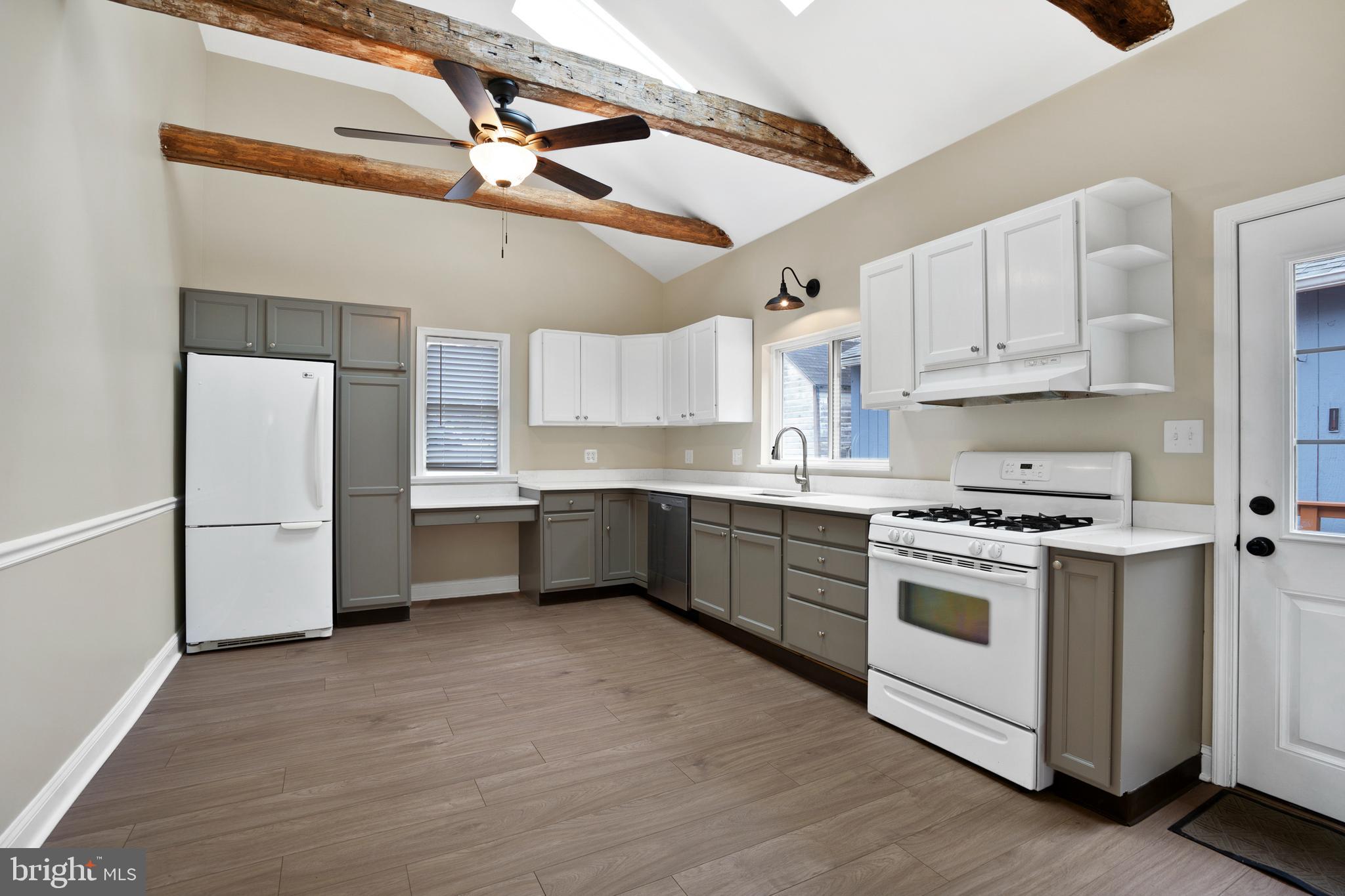 122 Garris Road Downingtown, PA 19335 - Photo 10 of 52 a kitchen with stainless steel appliances a stove a sink and a refrigerator