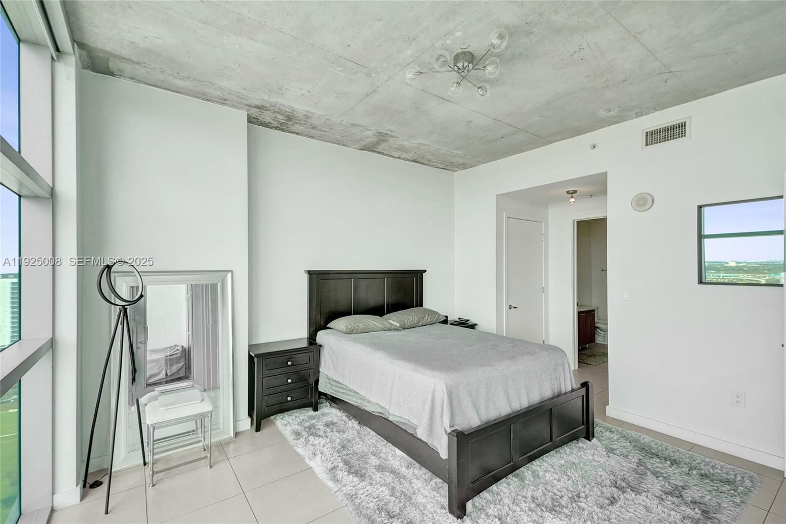 3301 Northeast 1st Avenue, Unit H2205 Miami, FL 33137 - Photo 12 of 28 a bedroom with a bed and a window
