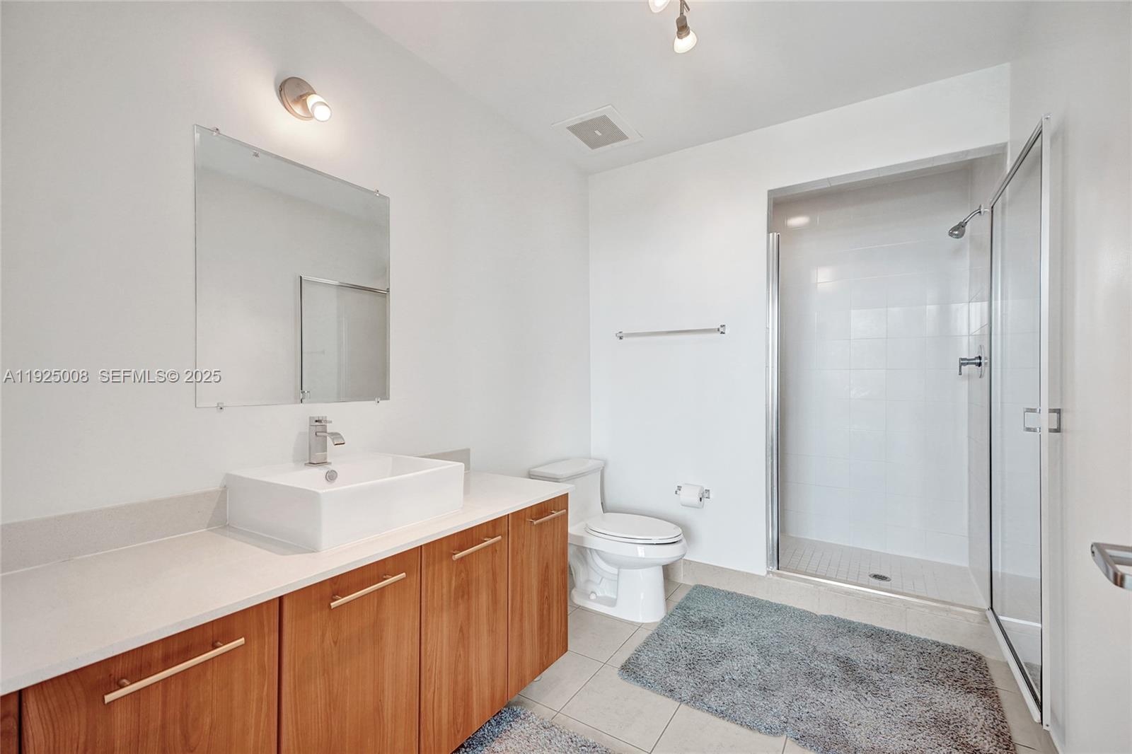 3301 Northeast 1st Avenue, Unit H2205 Miami, FL 33137 - Photo 13 of 28 a bathroom with a sink a toilet and shower