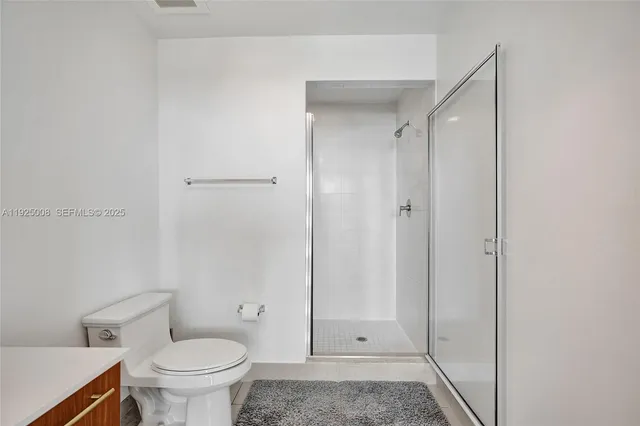 a bathroom with a shower and a toilet