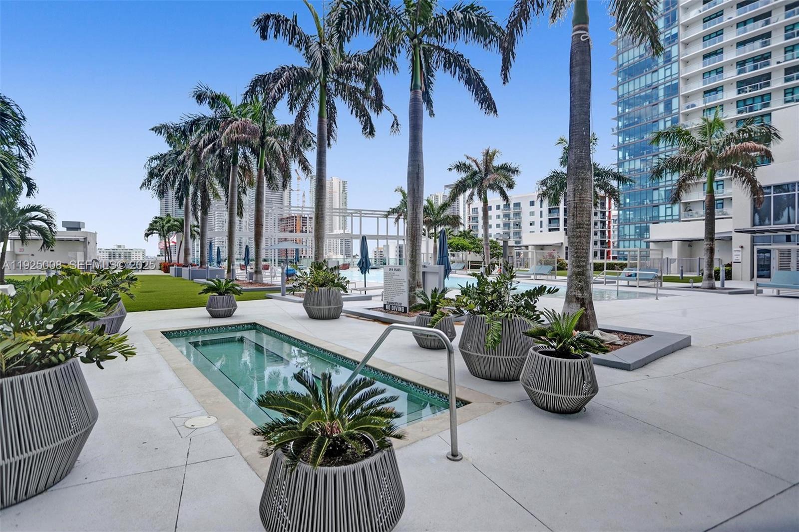 3301 Northeast 1st Avenue, Unit H2205 Miami, FL 33137 - Photo 17 of 28 a view of a swimming pool with potted plants and palm trees