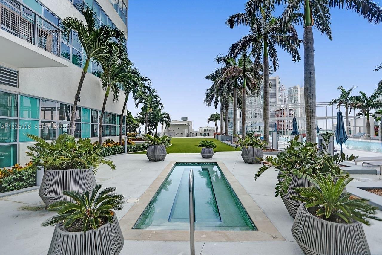 3301 Northeast 1st Avenue, Unit H2205 Miami, FL 33137 - Photo 5 of 28 a swimming pool with potted plants and palm trees