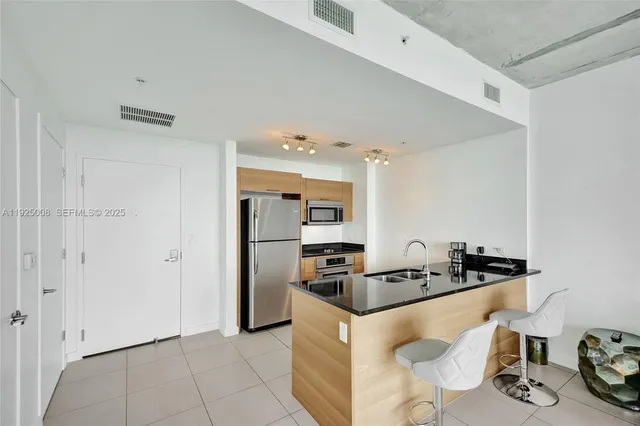 a kitchen with granite countertop a sink and cabinets