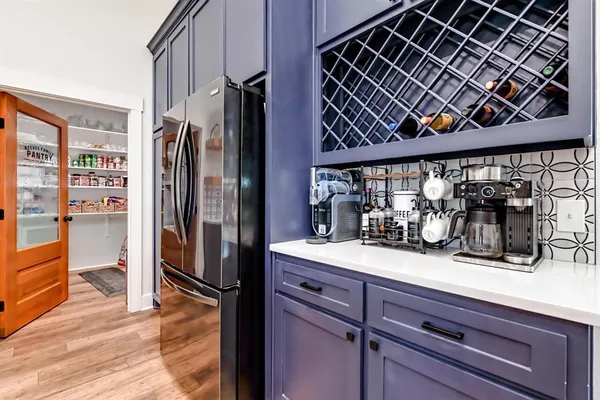 a kitchen with stainless steel appliances a refrigerator and a counter space