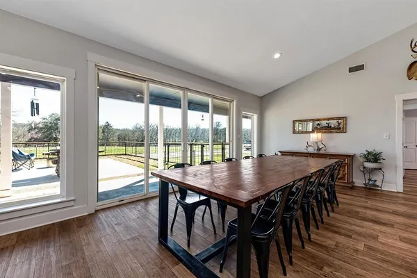 a view of a dining room with furniture window and wooden floor
