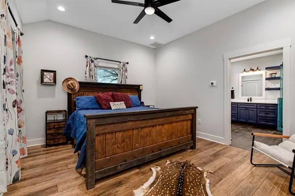 a bedroom with furniture and wooden floor