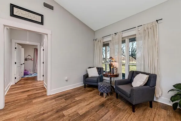 a living room with furniture and a wooden floor