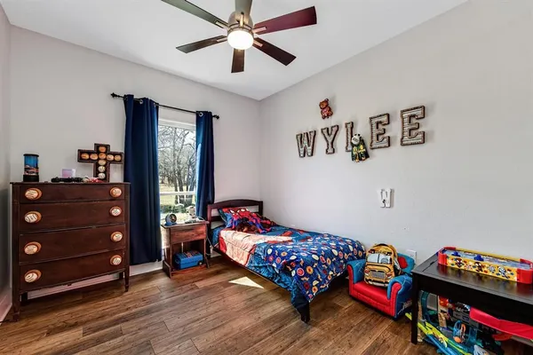 a bedroom with a bed and wooden floor