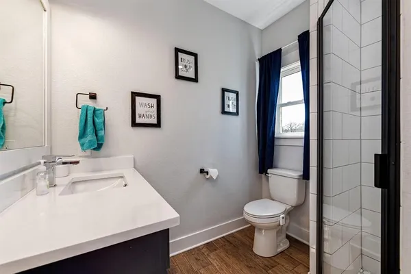 a bathroom with a sink toilet and shower