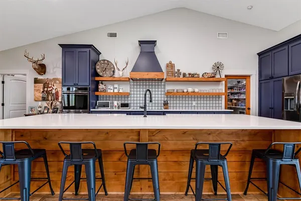 a kitchen with a table and chairs