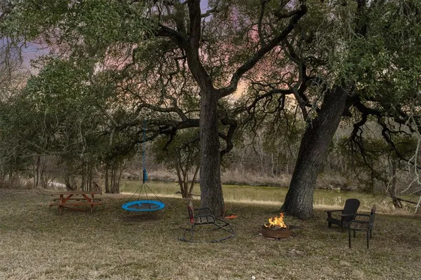 a view of a backyard with table and chairs