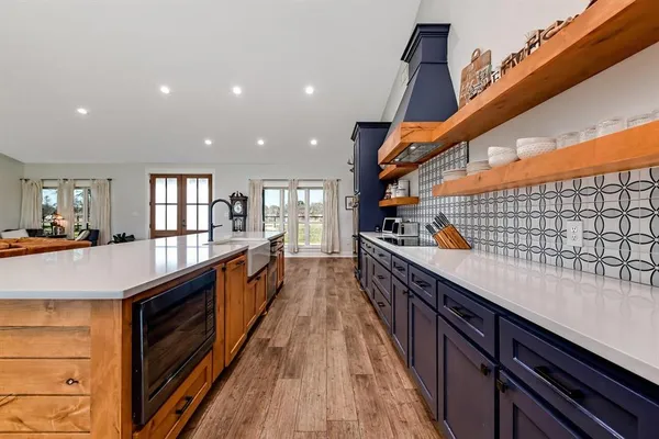 a open kitchen with stainless steel appliances granite countertop counter space and balcony