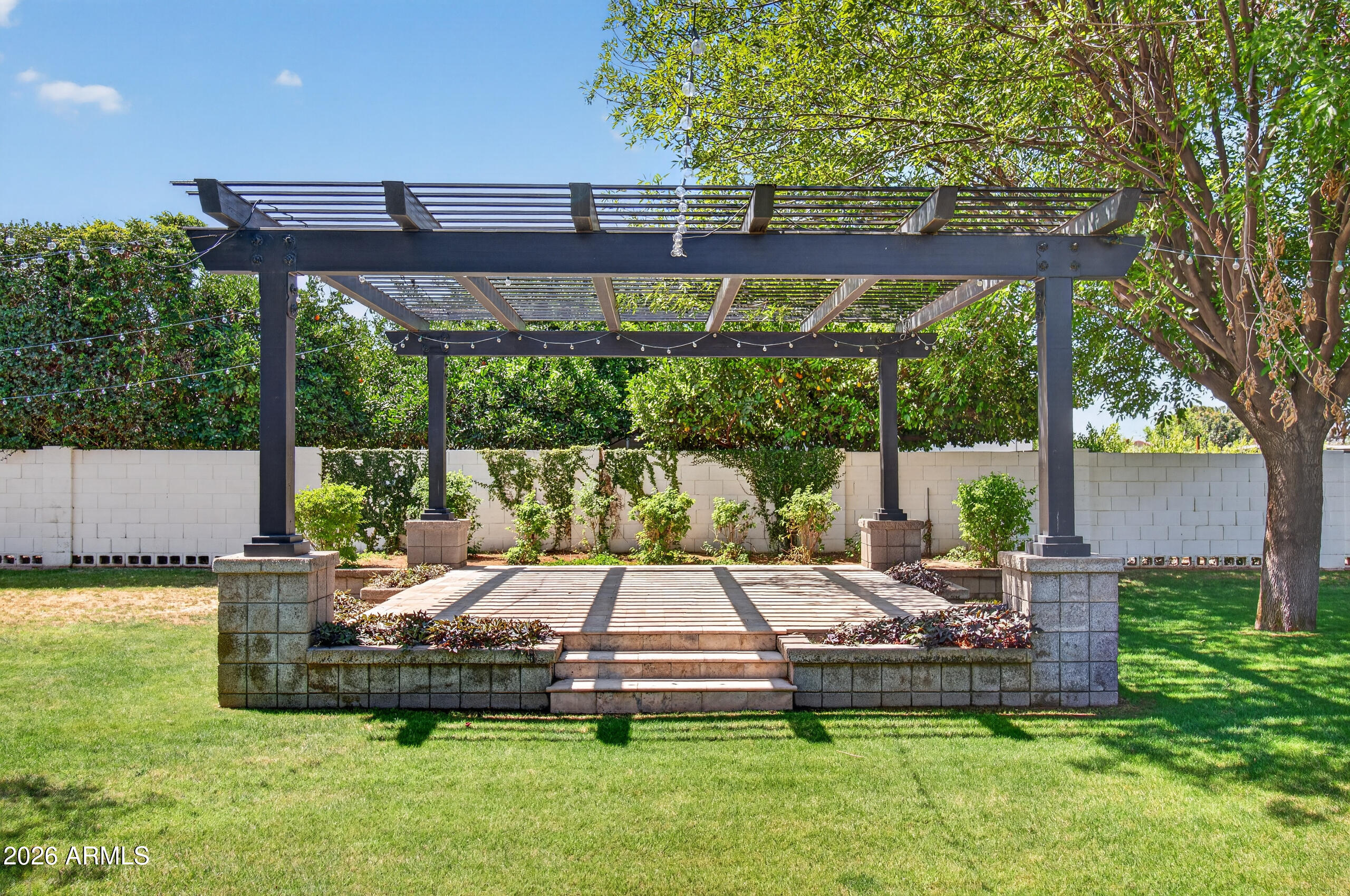 2677 East Queen Creek Road Gilbert, AZ 85297 - Photo 107 of 128 a view of a patio with table and chairs potted plants and large tree