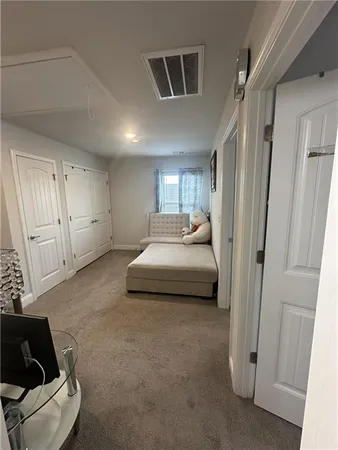 a bedroom with a bed and a couch