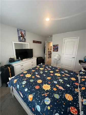 a bedroom with bed and window