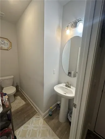 a bathroom with a sink mirror and toilet