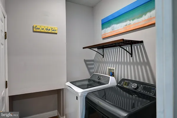 a view of hallway with wooden floor and furniture