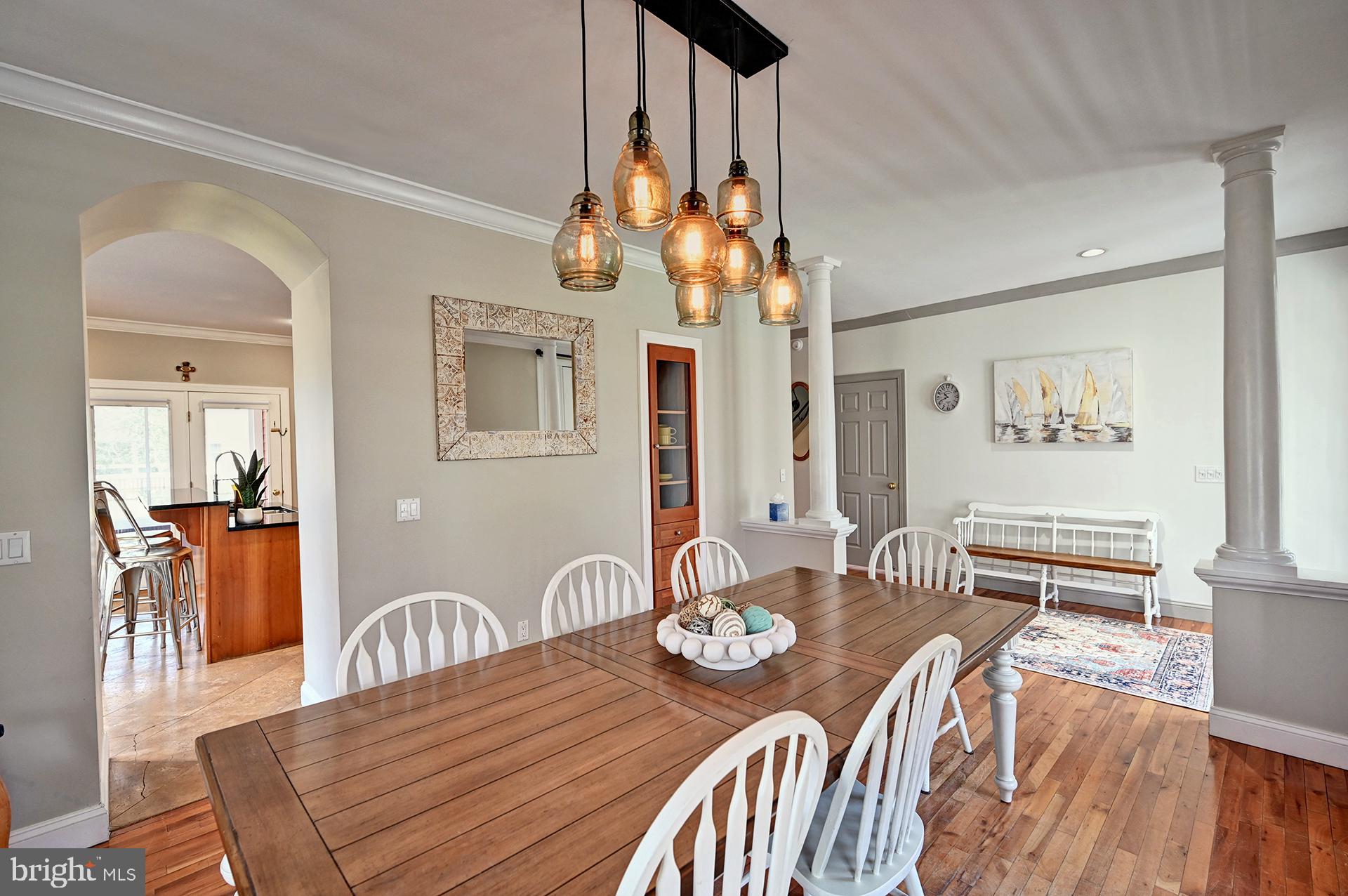 31765 Hickory Manor Road Frankford, DE 19945 - Photo 4 of 53 a view of a dining room with furniture a chandelier and wooden floor