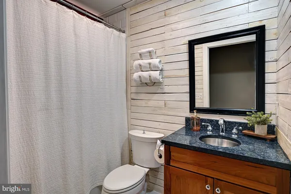 a dining room with wooden floor a ceiling fan and a window