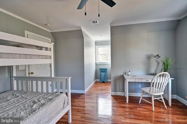 a bedroom with a bed window and couch