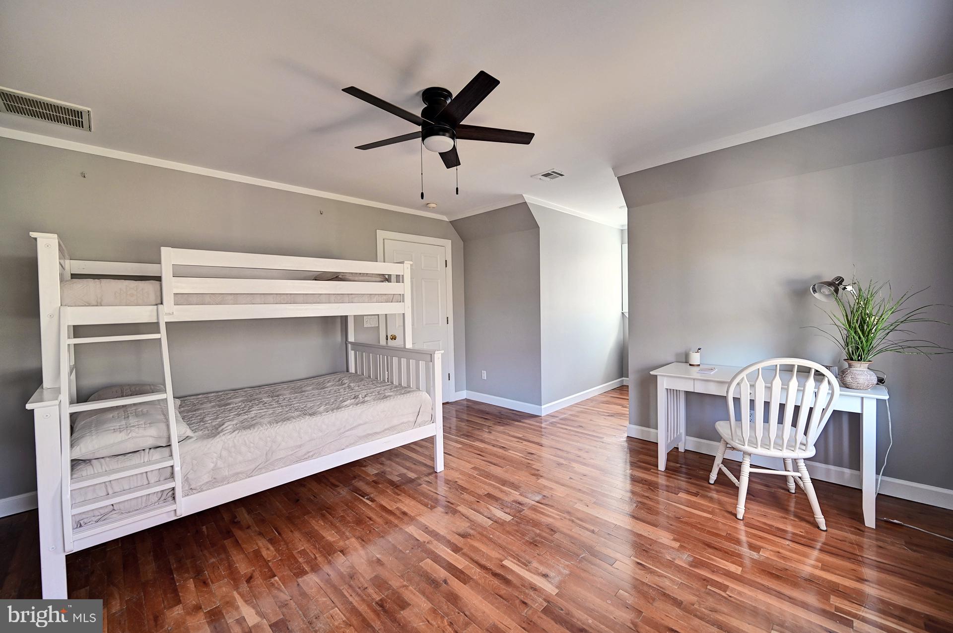 31765 Hickory Manor Road Frankford, DE 19945 - Photo 45 of 53 a dining room with wooden floor a ceiling fan and a window