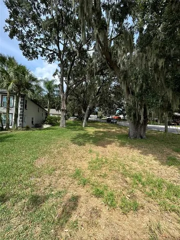 a view of a backyard with swimming pool