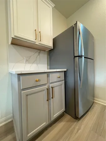a kitchen with a stove and a wooden floor