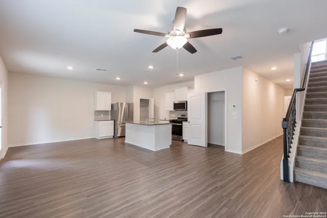a view of kitchen with stainless steel appliances refrigerator stove microwave and cabinets