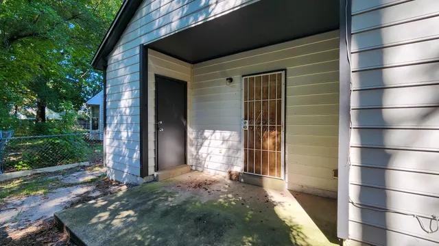 a view of a house with a door and wooden walls