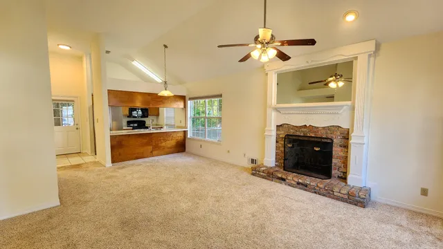 a view of a kitchen with a sink and a refrigerator