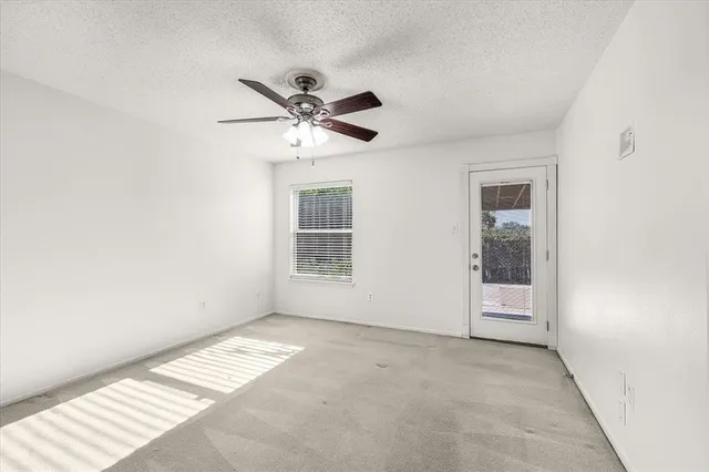 a view of kitchen with cabinets and window