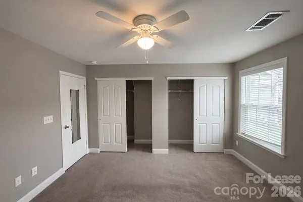 a view of a livingroom with a ceiling fan and window