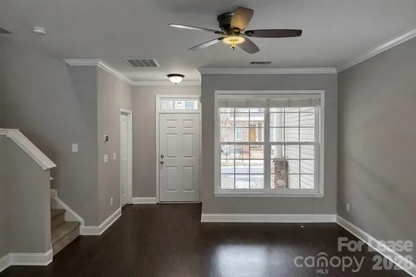 a view of room with hardwood floor and ceiling fan