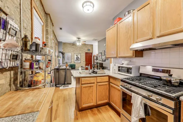 a kitchen with a sink appliances and cabinets