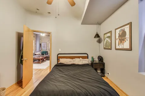 a bedroom with furniture and a wooden floor