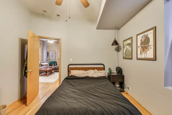 a bedroom with furniture and a wooden floor