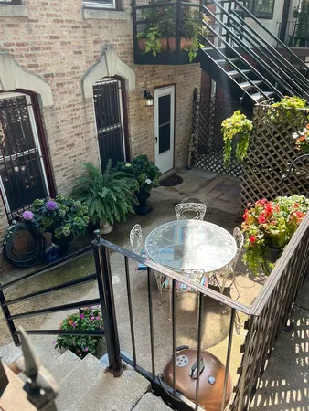 a outdoor dining area with furniture and flowers